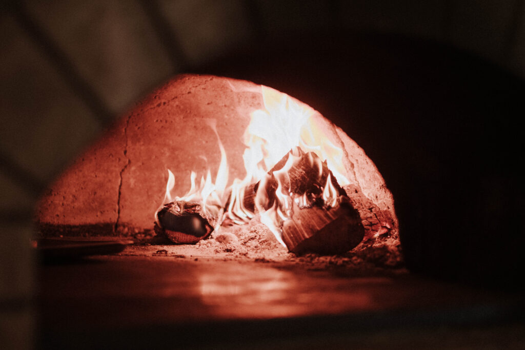 The wood-fired oven glowing at Amalfi