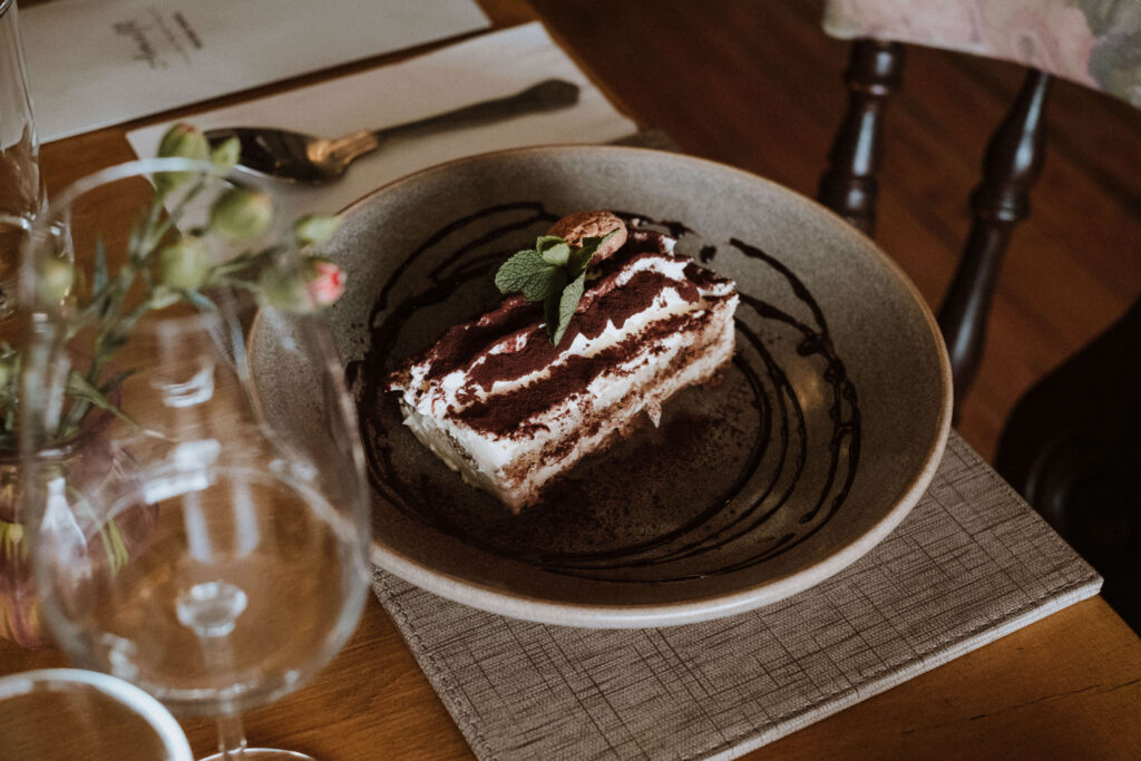 Tiramisu dusted with cocoa on a stoneware plate