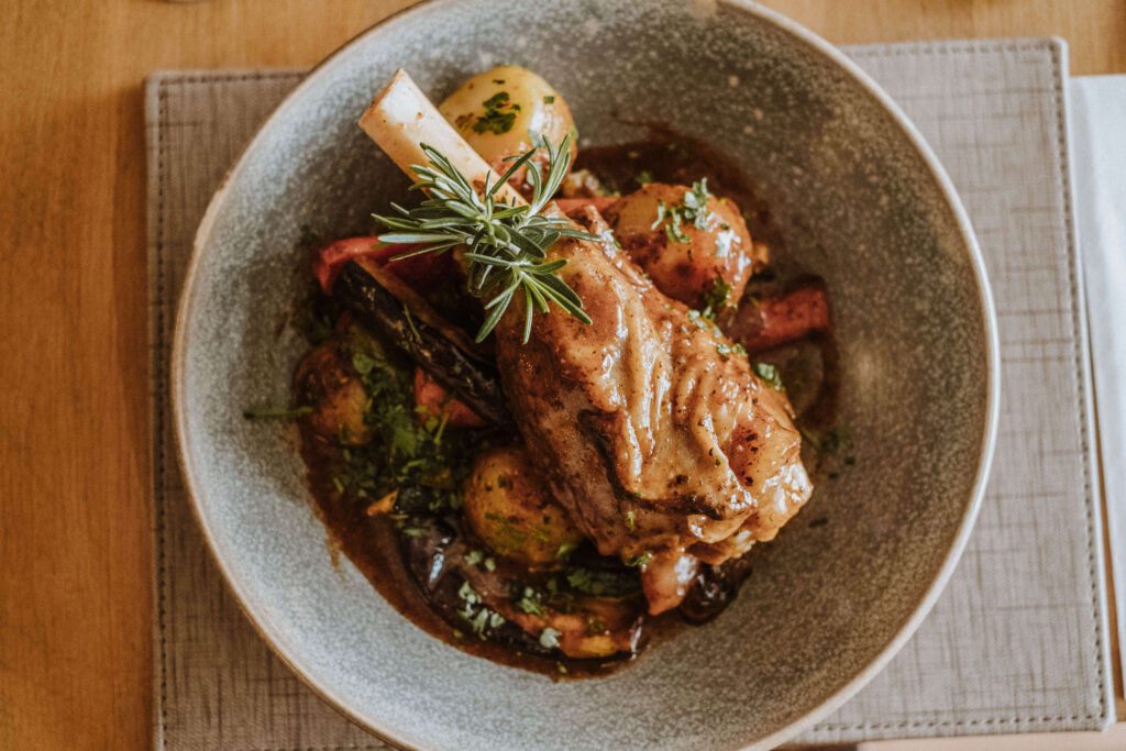 Branzino all'Amalfitana: baked sea bass fillet with potatoes, peppers and rosemary