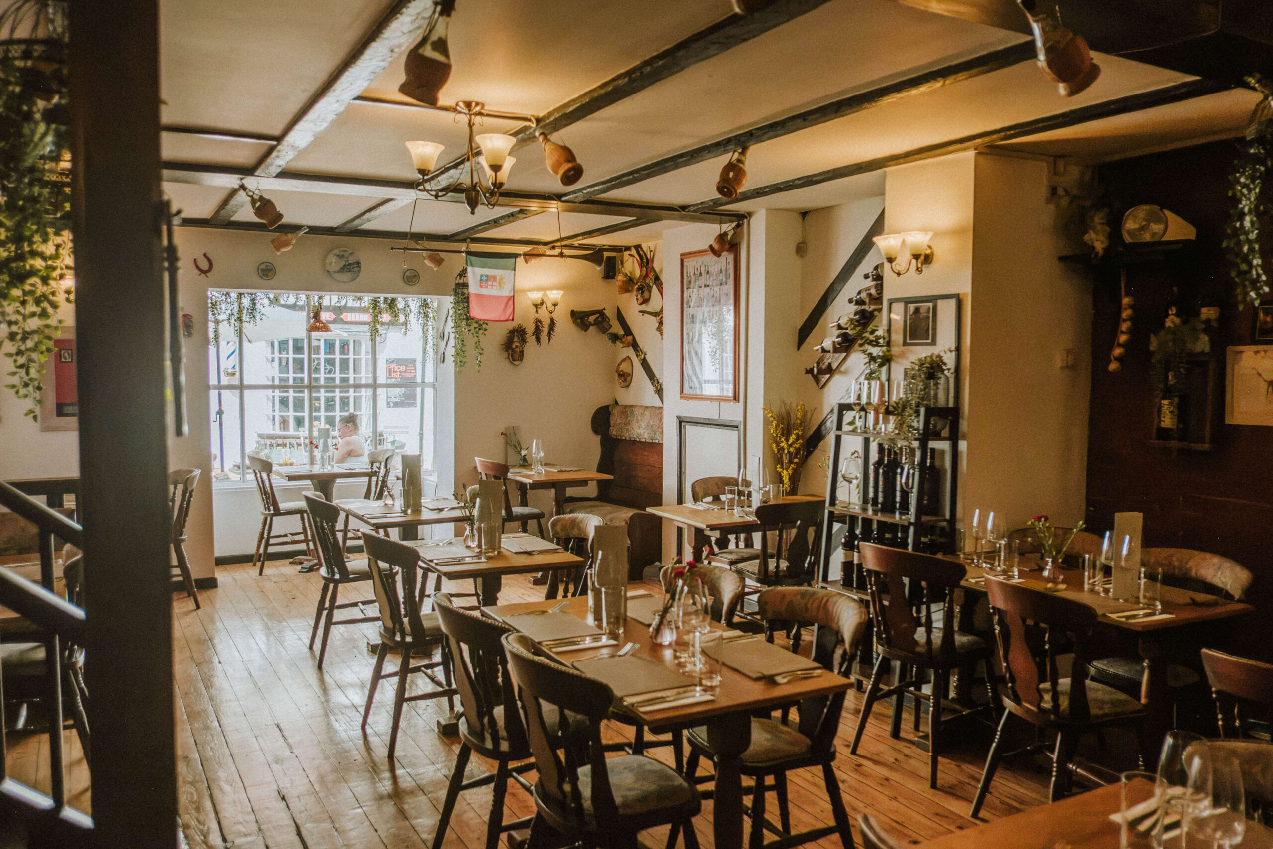 The Amalfi dining room in Hythe, tables set close together under warm light