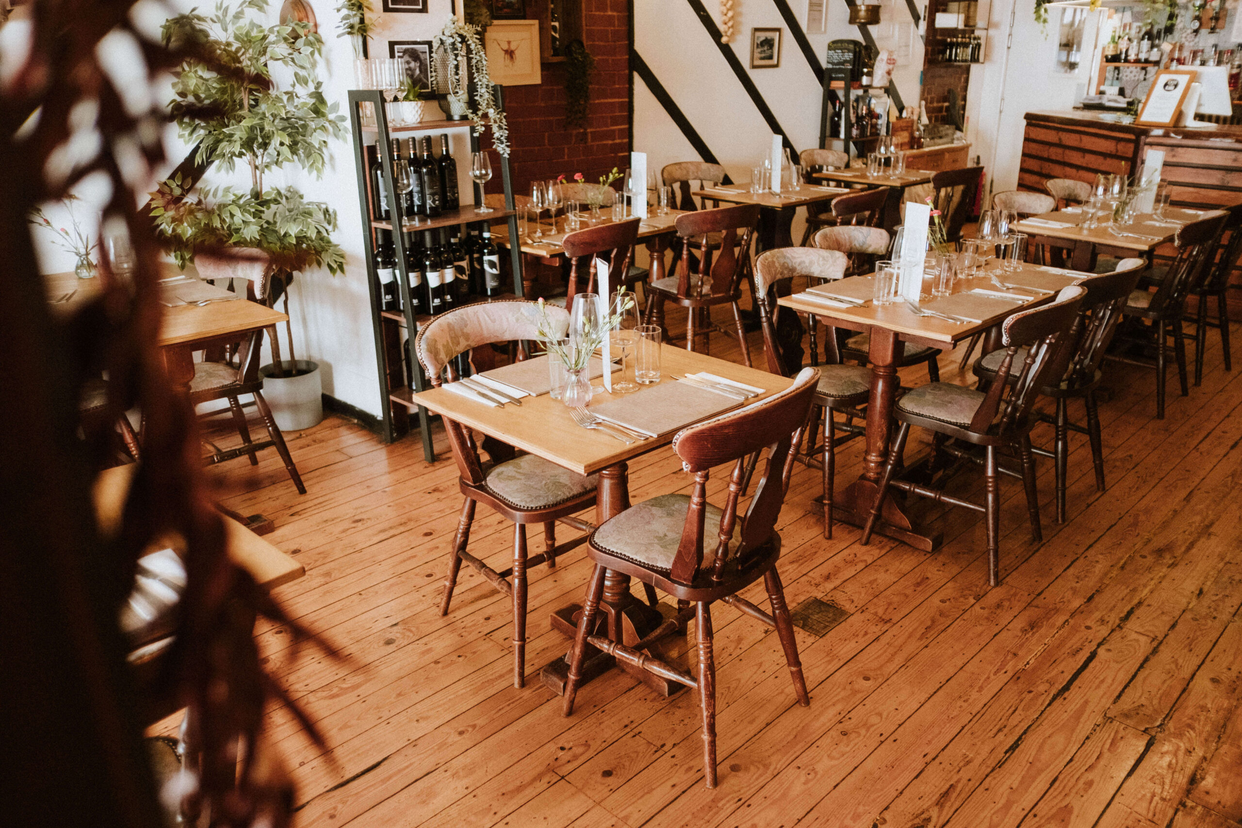 The dining room at Amalfi, Hythe, laid for service in warm afternoon light